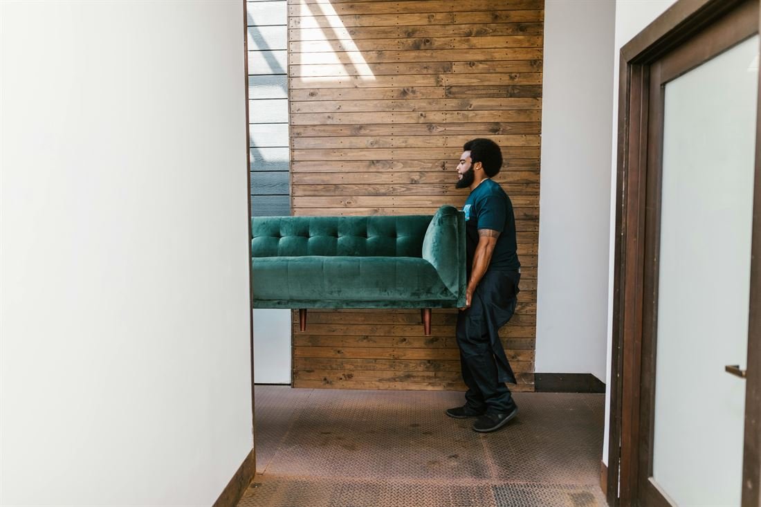 Express mover carefully carrying a sofa during a residential move in Ottawa